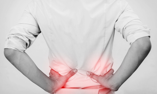 Young man in casual office shirt having hip pain