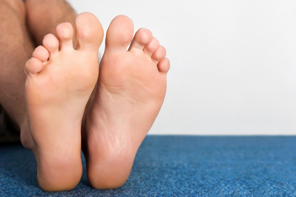 Healthy male feet feeling comfortable at home.