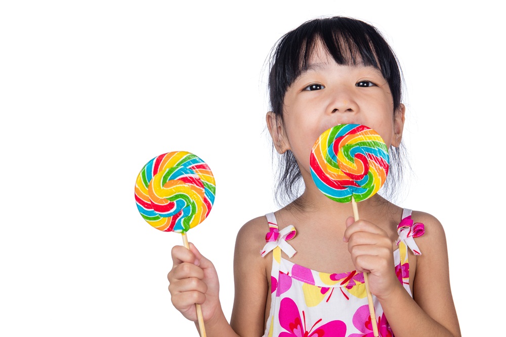 Asian Little Chinese girl eating lollipop