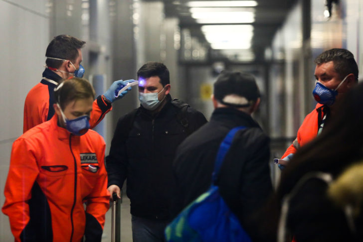KRAKOW, POLAND - FEBRUARY 26: Airport officials set obstacles to monitor passengers' body temperature as passengers with face masks exit Krakow Aiport after landing in Krakow, Poland on February 26, 2020. Polish Government has taken preventing measure at the airports due to the Coronavirus outbreak in Italy and now spreading around Europe. (Photo by Stringer/Anadolu Agency via Getty Images)